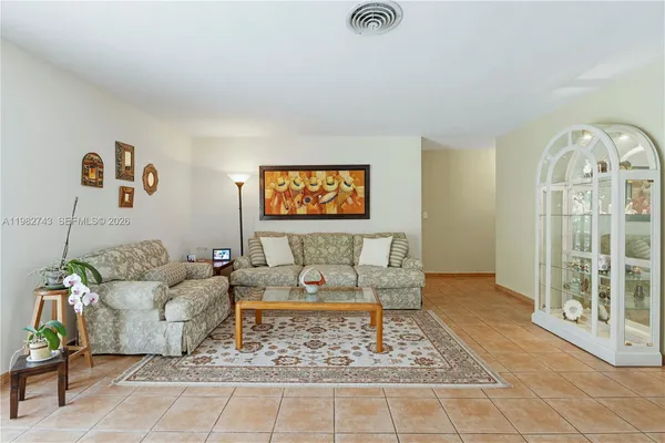 a living room with furniture and a painting