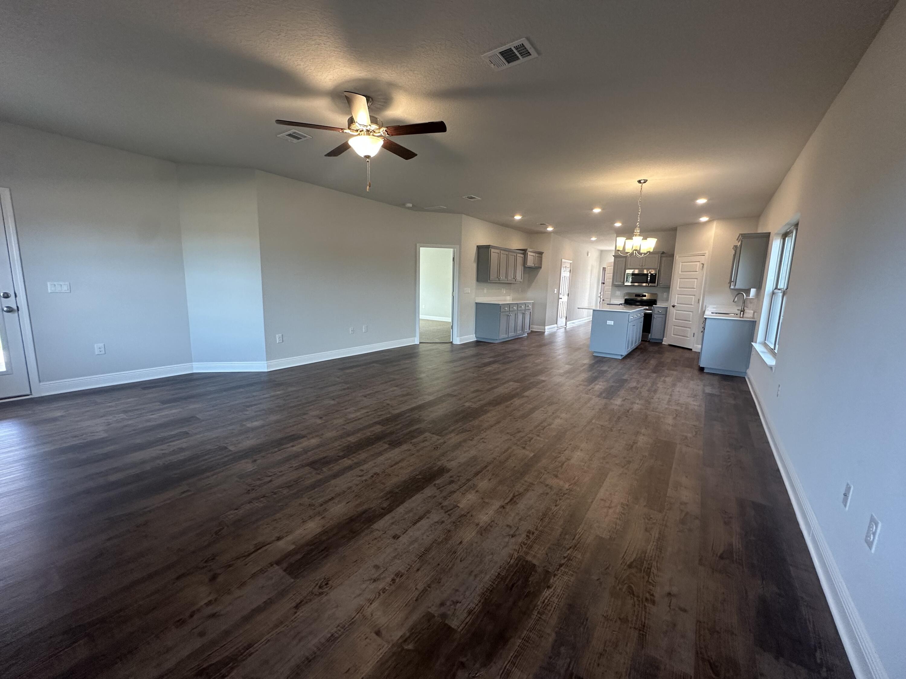 193 Ridgeway Circle Crestview, FL 32536 - Photo 12 of 33 a view of a livingroom with a furniture wooden floor and chandelier