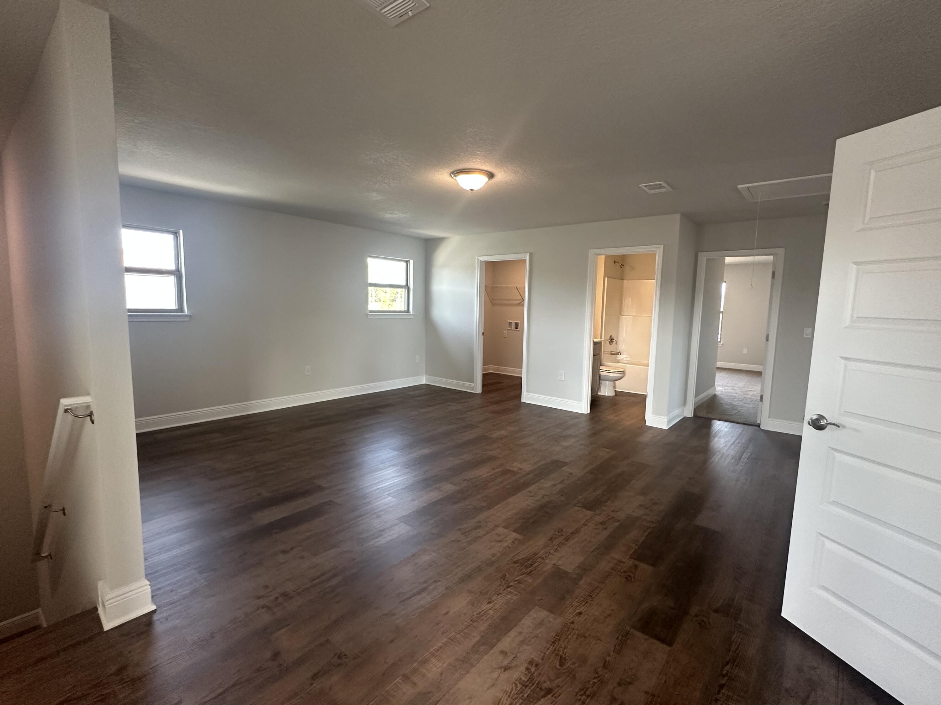 193 Ridgeway Circle Crestview, FL 32536 - Photo 20 of 33 a view of an empty room with wooden floor and a window