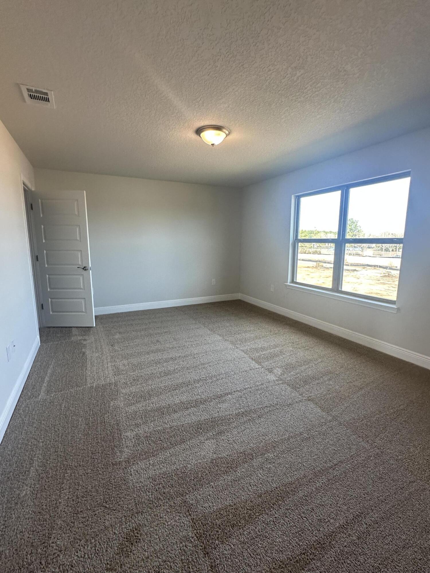 193 Ridgeway Circle Crestview, FL 32536 - Photo 27 of 33 an empty room with windows and closet