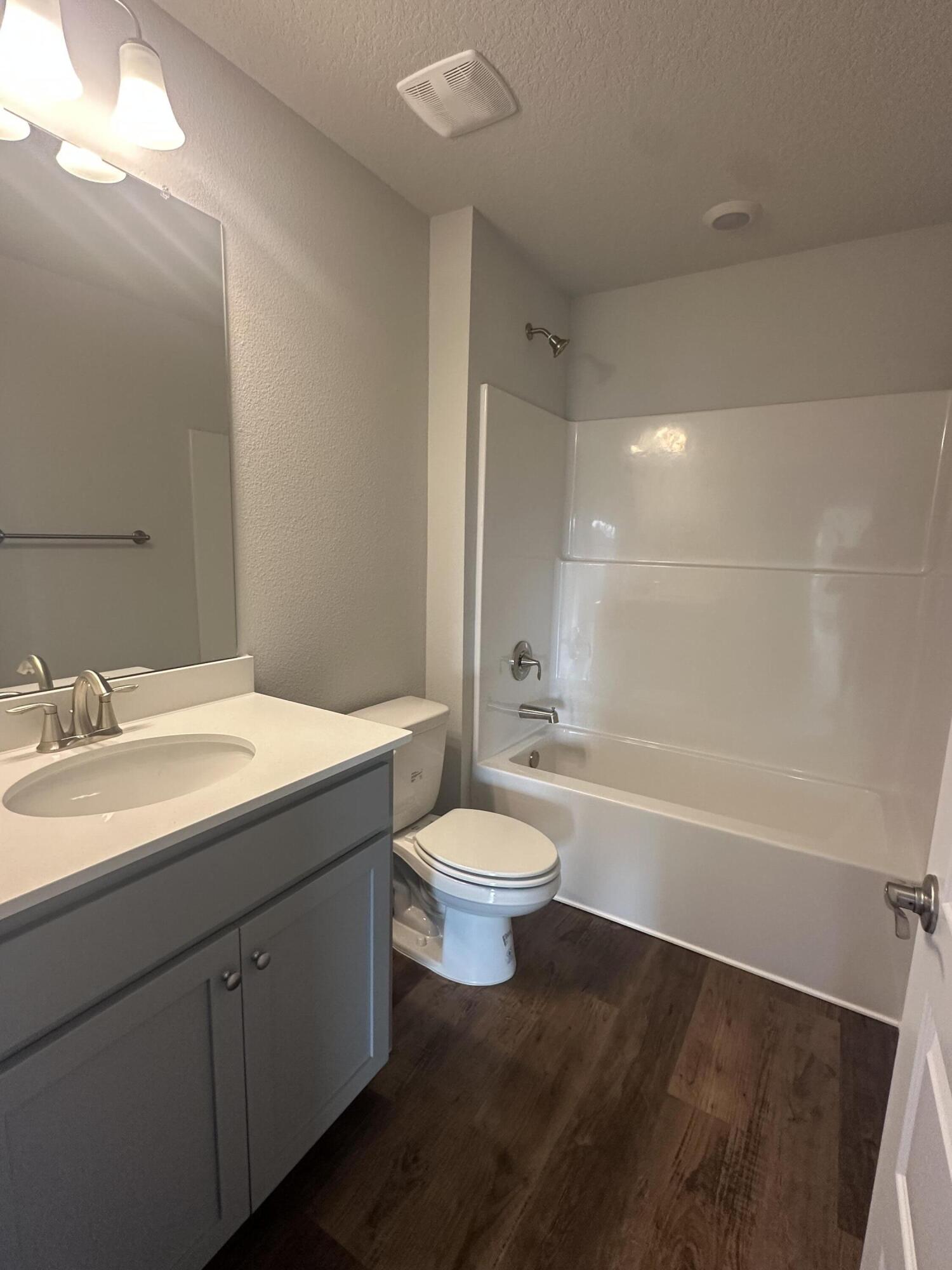 193 Ridgeway Circle Crestview, FL 32536 - Photo 29 of 33 a bathroom with a bathtub shower sink vanity mirror and toilet