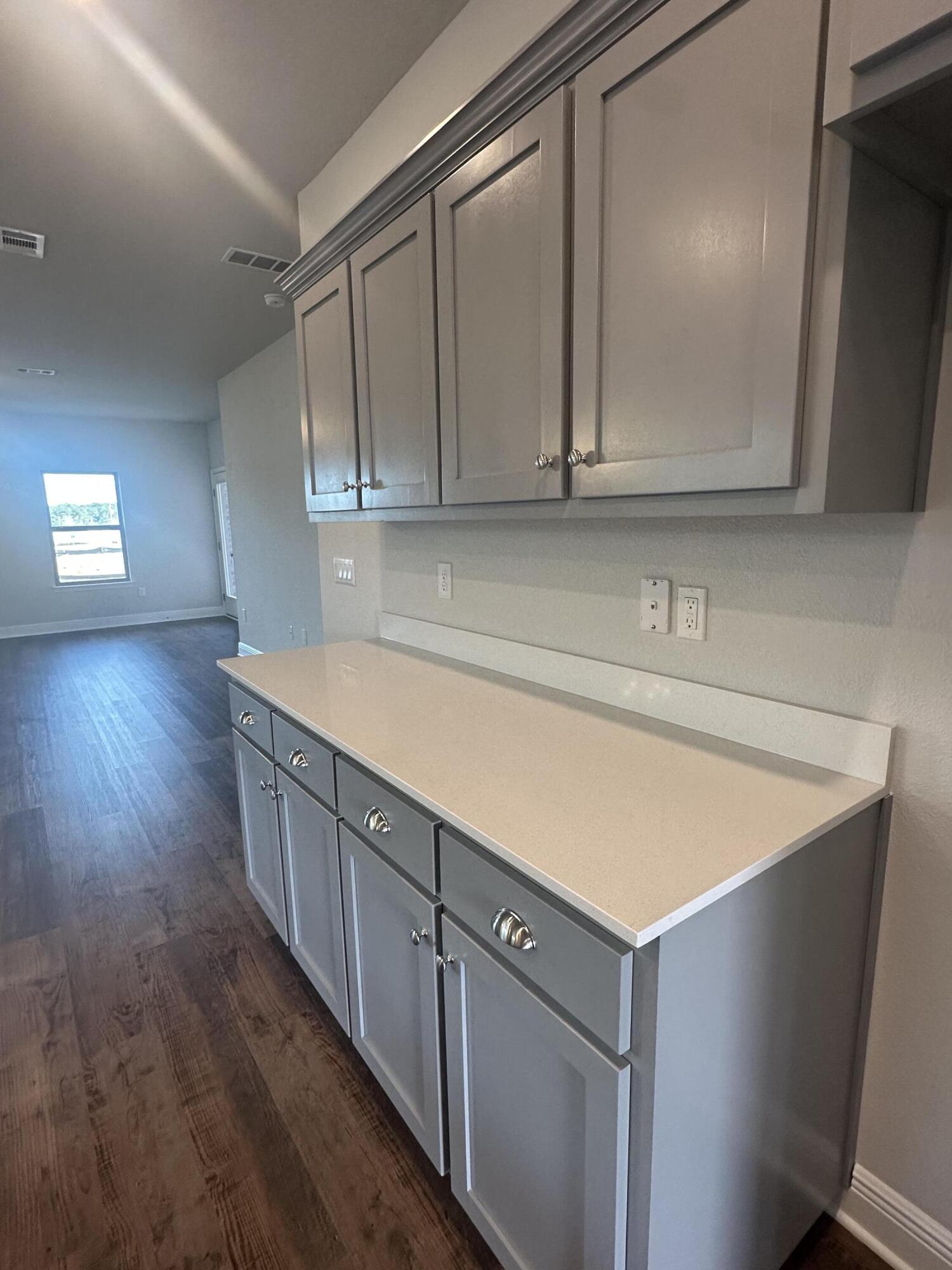 193 Ridgeway Circle Crestview, FL 32536 - Photo 9 of 33 a kitchen with sink cabinets and wooden floor