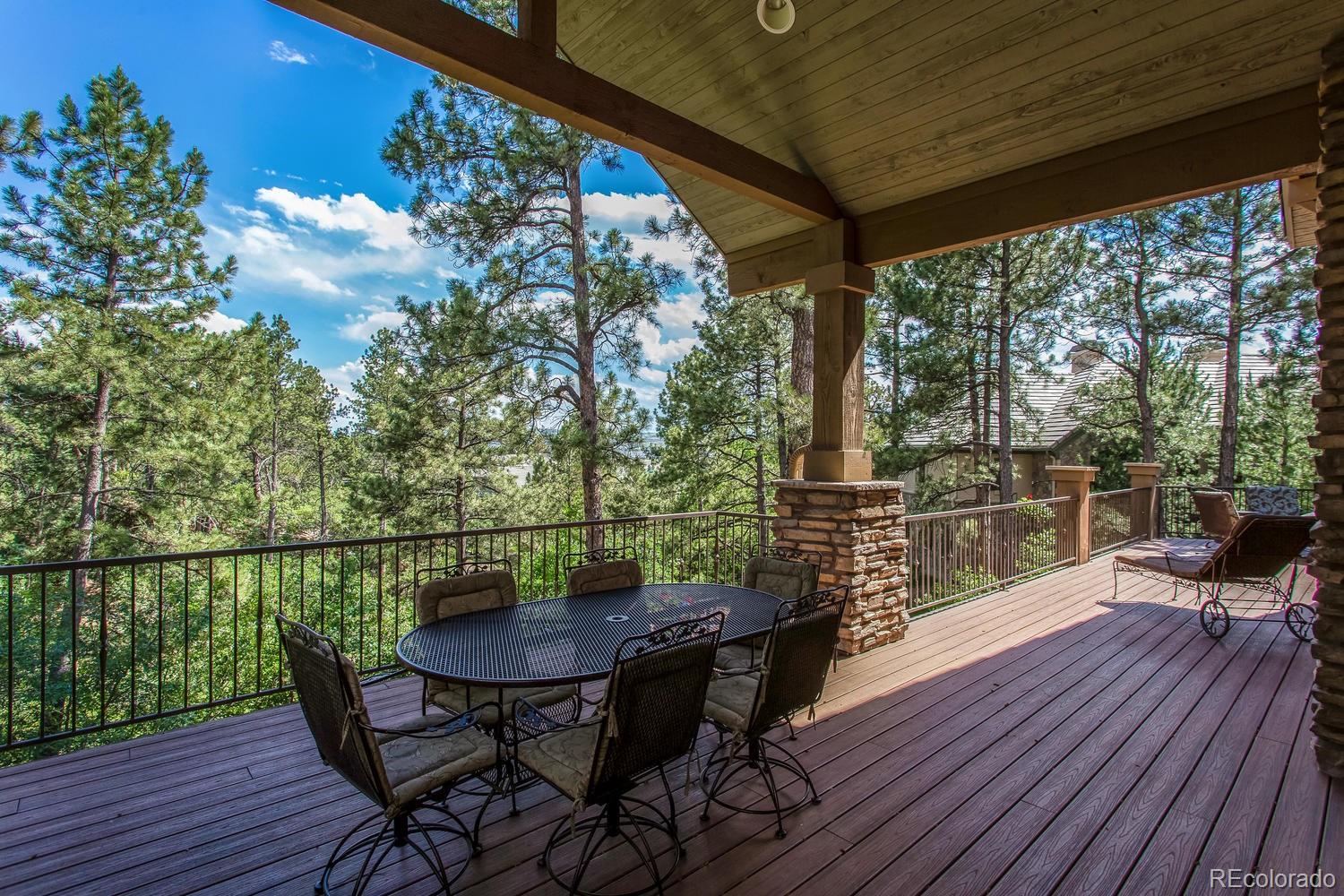 646 Ruby Trust Drive Castle Rock, CO 80108 - Photo 15 of 35 a view of a chairs and table on the wooden deck
