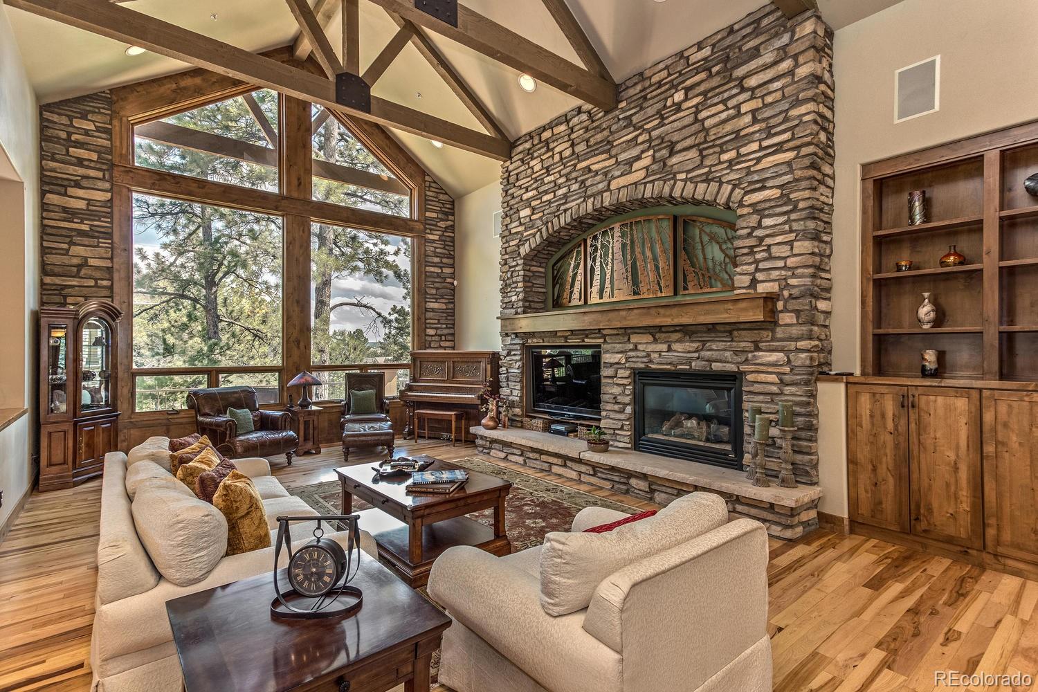 646 Ruby Trust Drive Castle Rock, CO 80108 - Photo 17 of 35 a living room with furniture a fireplace and large windows