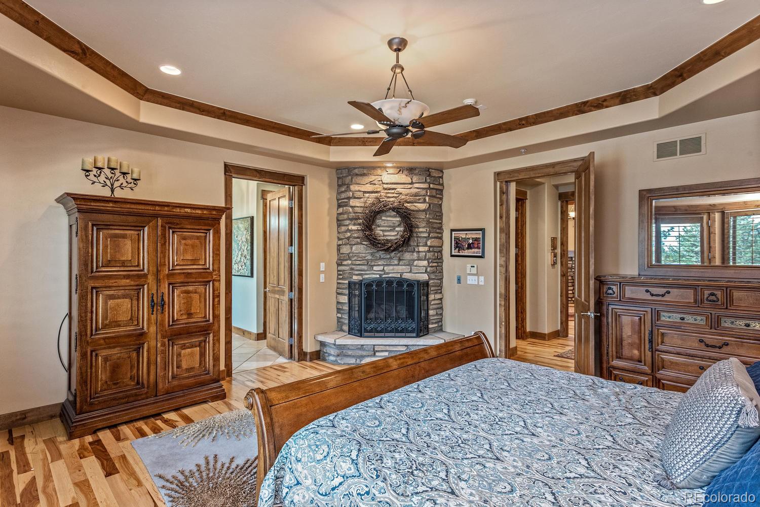 646 Ruby Trust Drive Castle Rock, CO 80108 - Photo 26 of 35 a bedroom with a bed dresser and a large mirror