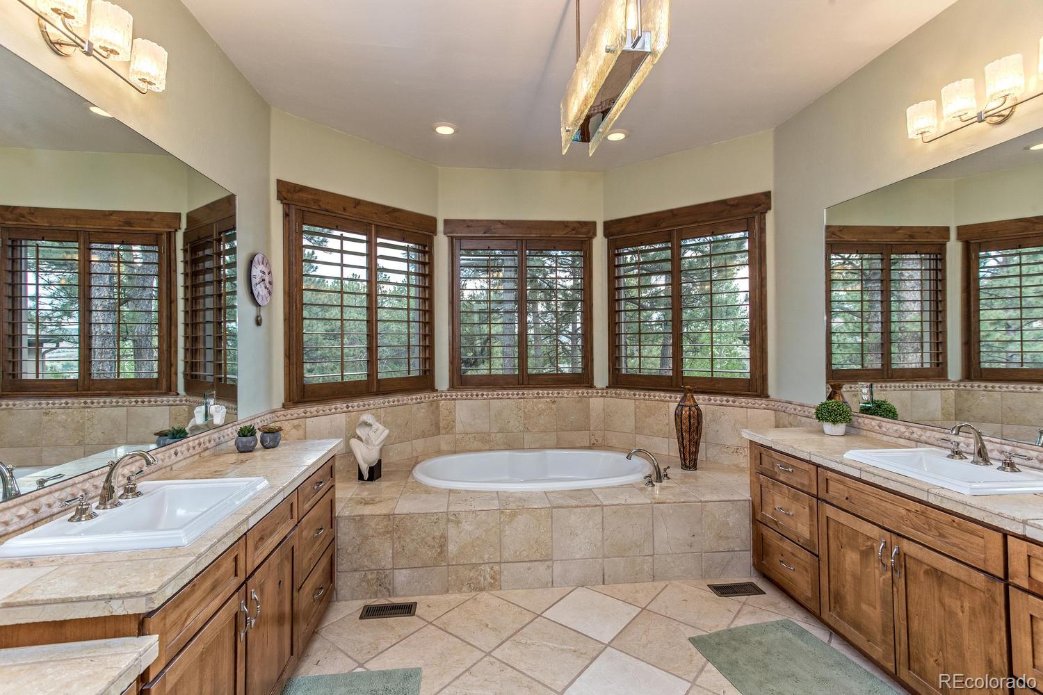 646 Ruby Trust Drive Castle Rock, CO 80108 - Photo 27 of 35 a spacious bathroom with sinks mirror and a bath tub