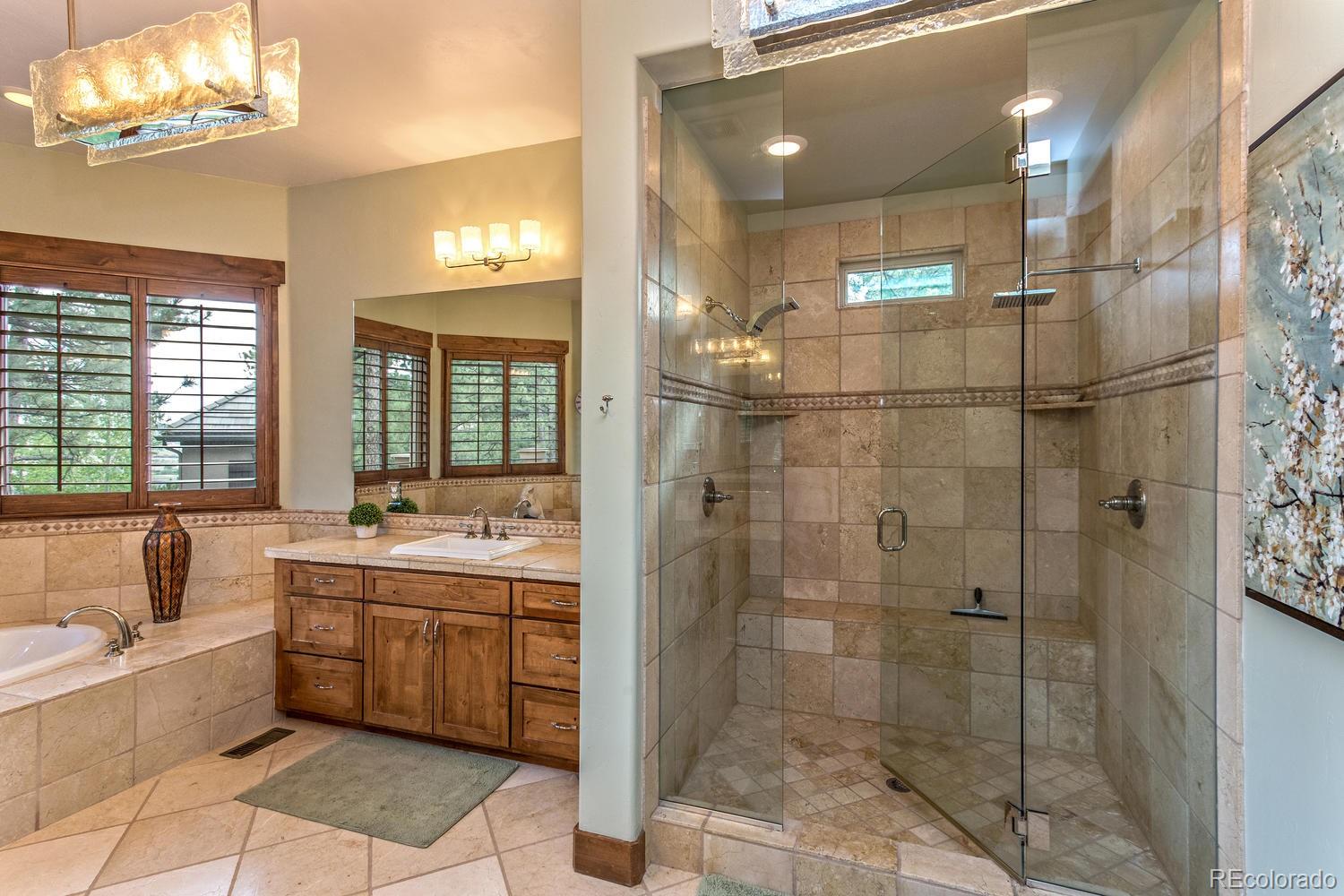 646 Ruby Trust Drive Castle Rock, CO 80108 - Photo 28 of 35 a bathroom with a bathtub a shower a sink and mirror