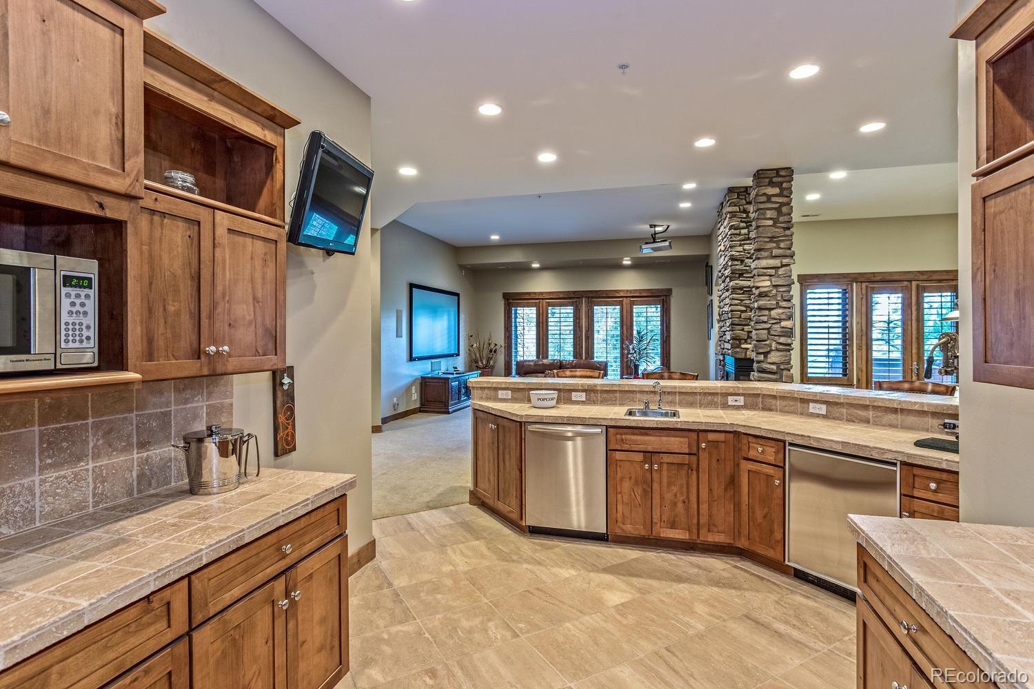 646 Ruby Trust Drive Castle Rock, CO 80108 - Photo 30 of 35 a large kitchen with stainless steel appliances granite countertop a sink and a stove
