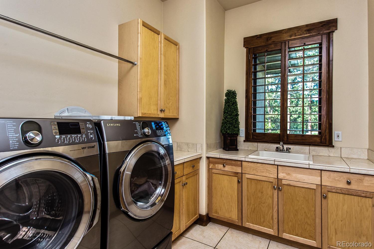 646 Ruby Trust Drive Castle Rock, CO 80108 - Photo 34 of 35 a utility room with sink dryer and washer