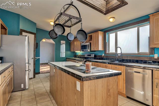 39301 Jacobson Road Rush, CO 80833 - Photo 7 of 40 Bright and OPEN kitchen with electric stove top and newer gas stove/range with split convection oven (self cleaning)