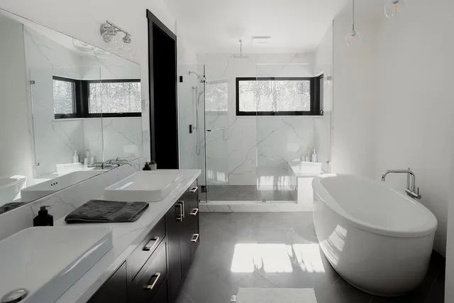 a bathroom with a tub sink and mirror