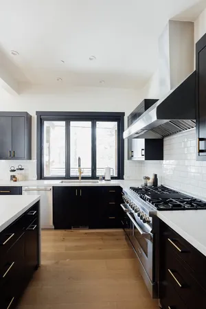 a large kitchen with stainless steel appliances granite countertop a stove and a sink