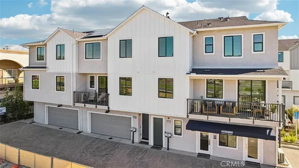 a view of a brick house with many windows