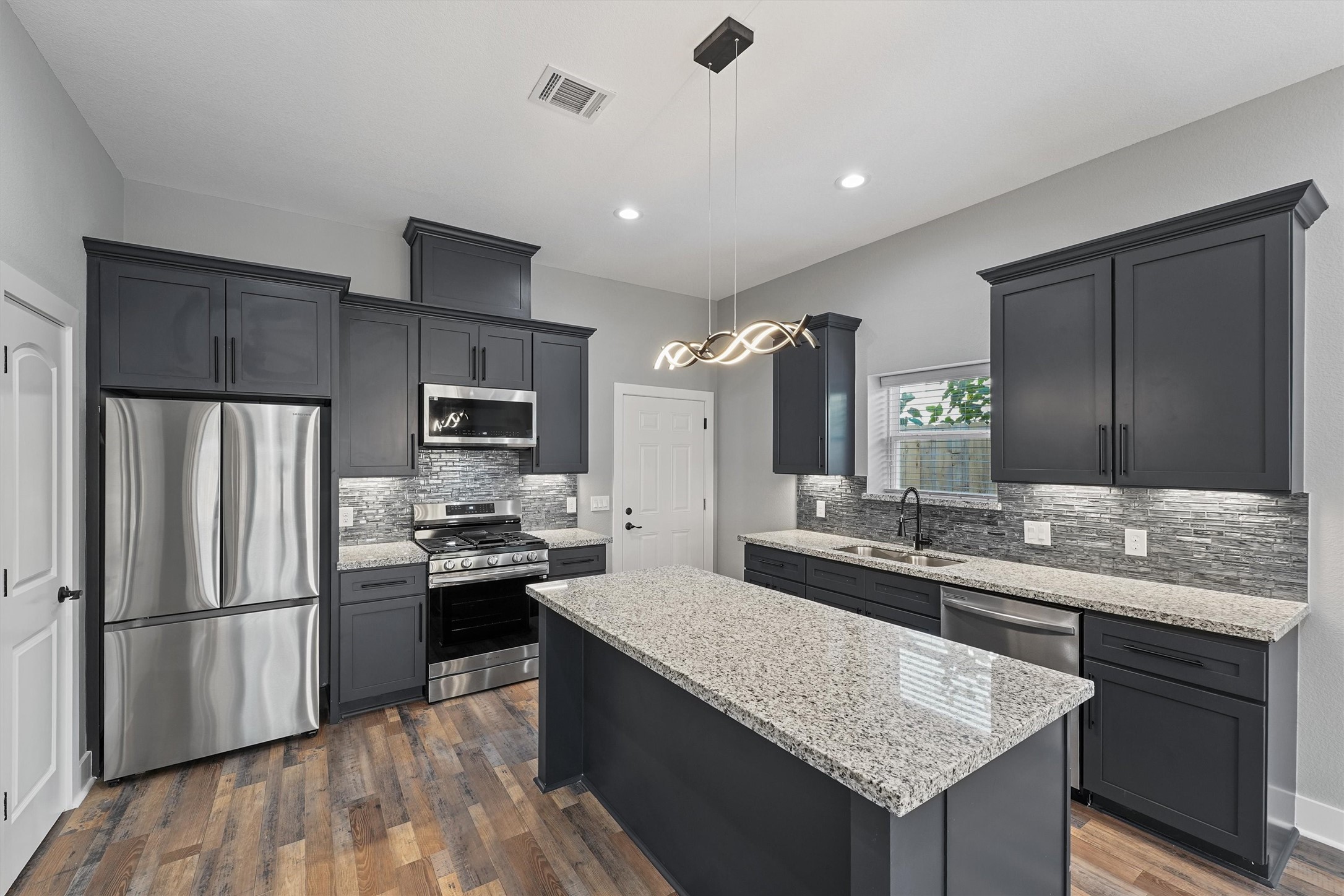 7704 Sealey Street Houston, TX 77088 - Photo 2 of 15 a kitchen with stainless steel appliances granite countertop a sink stove and refrigerator
