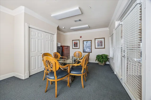 a dining room with furniture and window