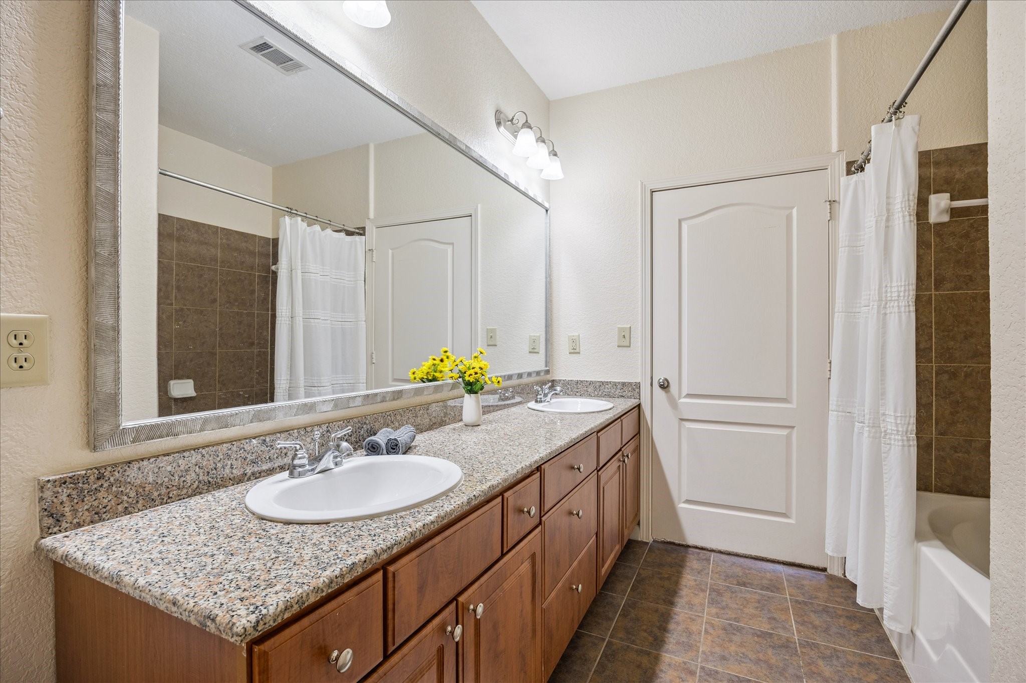 1711 Old Spanish Trail, Unit 448 Houston, TX 77054 - Photo 10 of 29 a bathroom with a granite countertop sink and a mirror