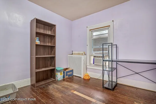 a view of a room with wooden floor and shelf