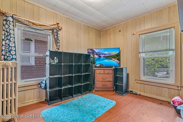 a view of room with window and wooden floor