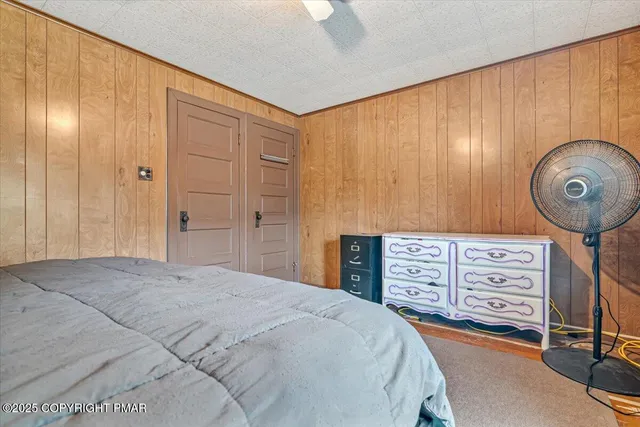a bedroom with a bed and cabinets