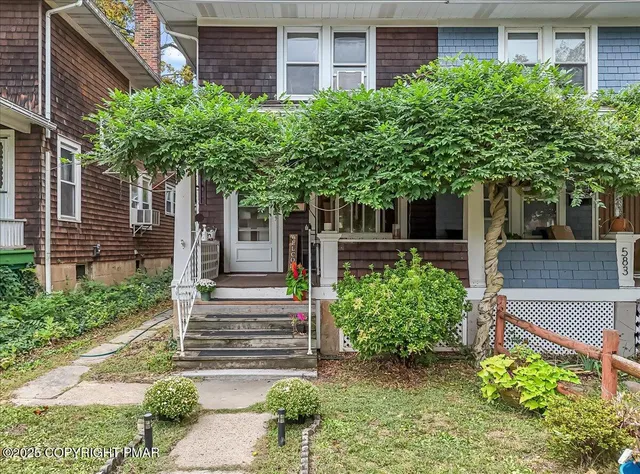 a house with a tree in front of it