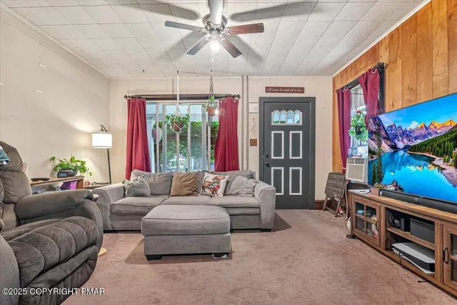 a living room with furniture and a flat screen tv