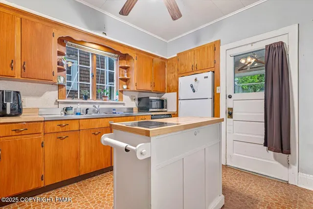 a kitchen with wooden cabinets and a stove