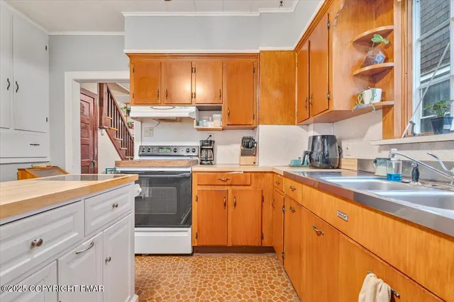 a kitchen with a sink stove and cabinets