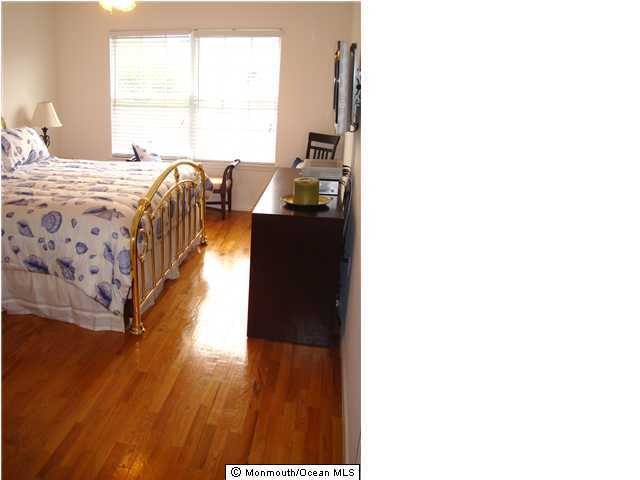 12 Racquet Road Wall, NJ 07719 - Photo 2 of 3 a bed room with a bed and a window