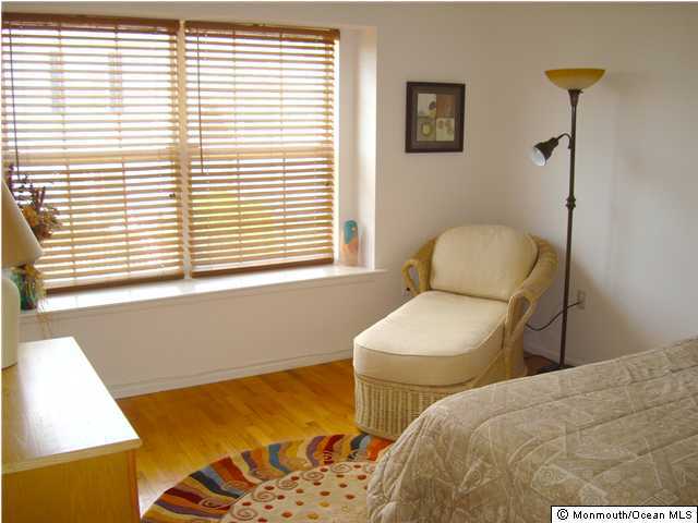 12 Racquet Road Wall, NJ 07719 - Photo 3 of 3 a bedroom with a bed and a window