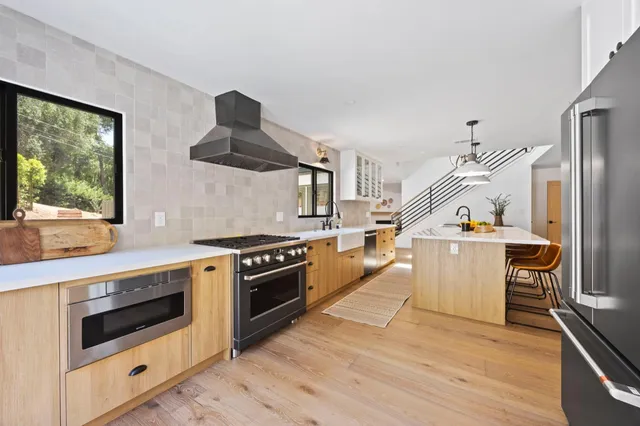 a kitchen with granite countertop a stove and a sink
