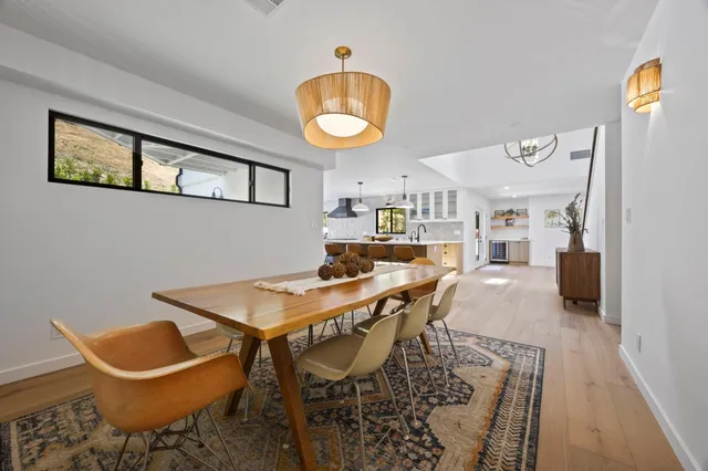a view of a dining room with furniture and a chandelier