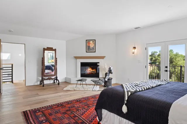 a bedroom with a bed and a fireplace