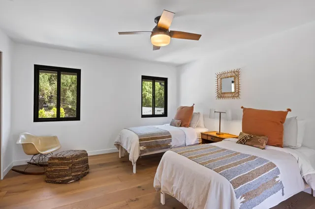 a bedroom with two beds and a window