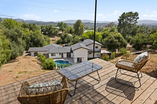 a view of a patio with a table chairs and a table