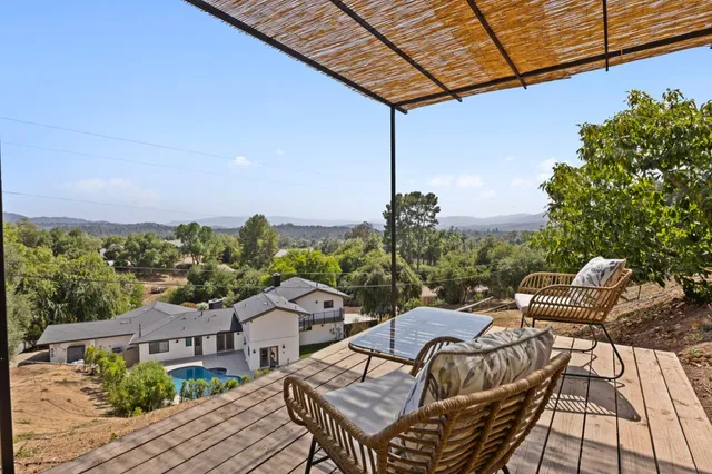 a view of a patio with couches under an umbrella