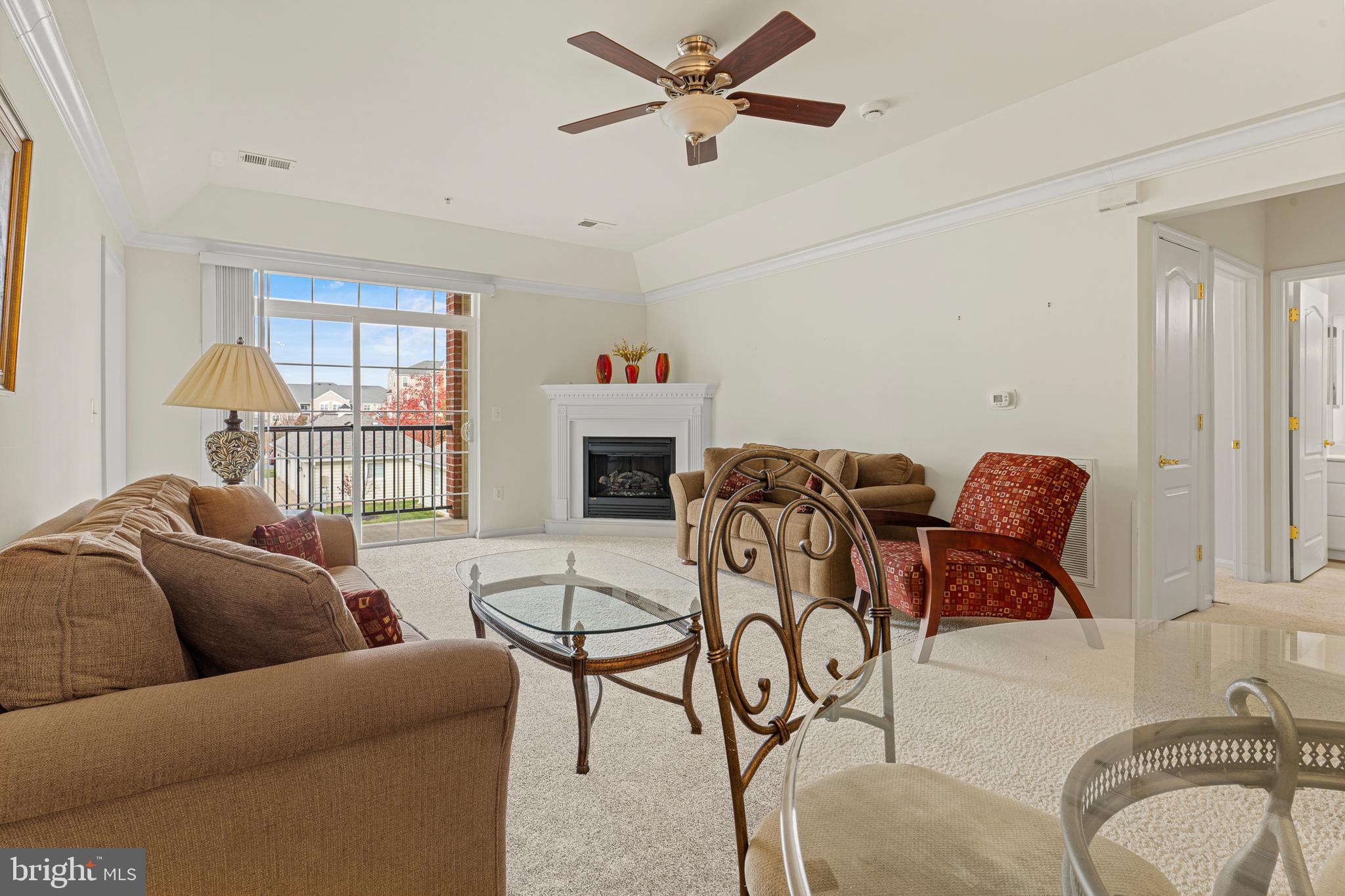 8615 Wandering Fox Trail, Unit 208 Odenton, MD 21113 - Photo 11 of 28 a living room with furniture a fireplace and a window