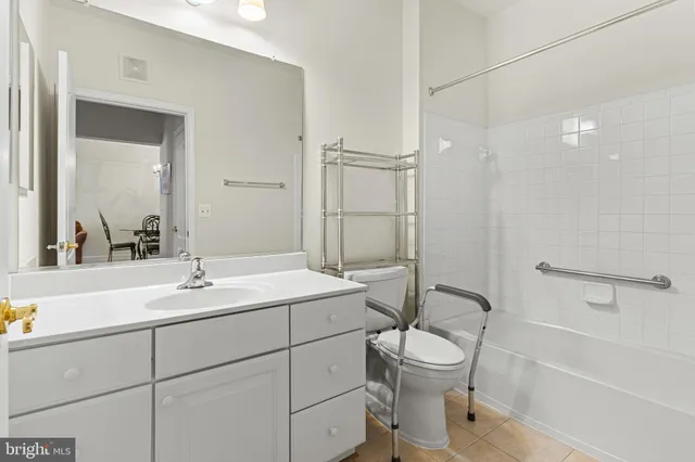 a bathroom with a toilet sink a mirror and shower