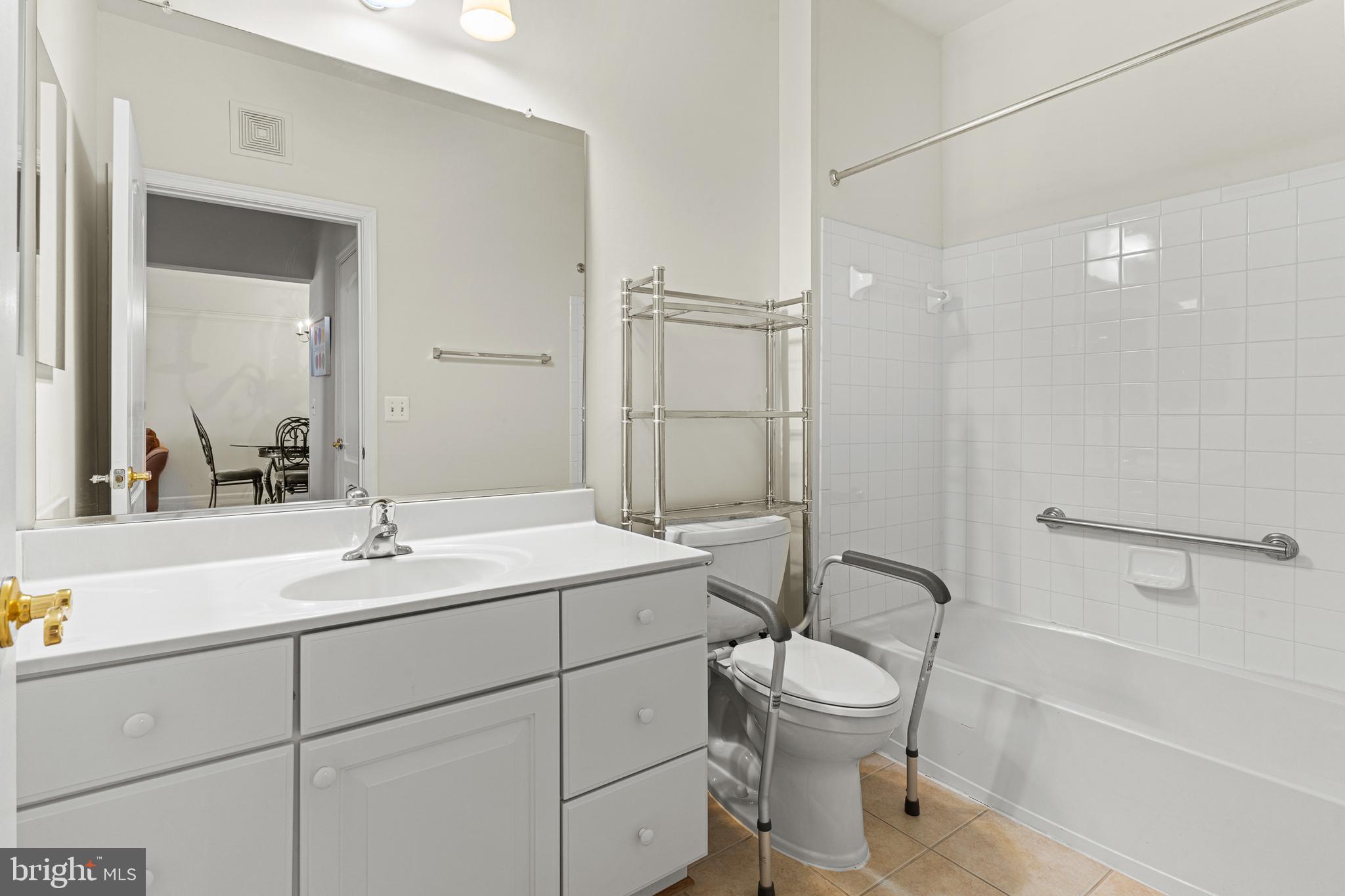 8615 Wandering Fox Trail, Unit 208 Odenton, MD 21113 - Photo 17 of 22 a bathroom with a toilet sink a mirror and shower