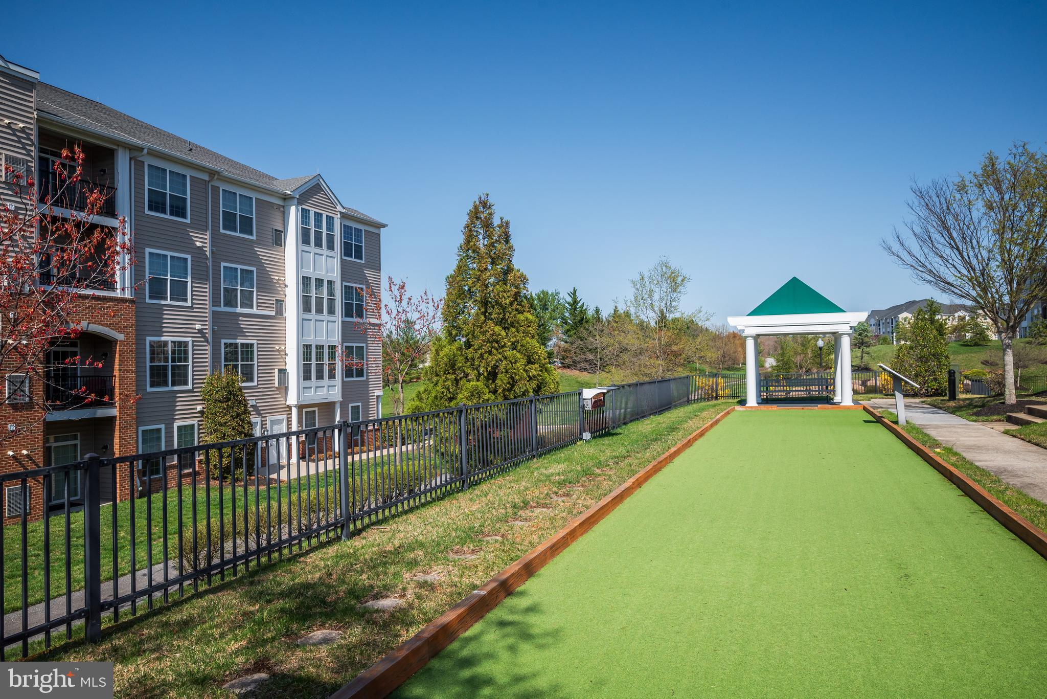 8615 Wandering Fox Trail, Unit 208 Odenton, MD 21113 - Photo 17 of 19 a front view of a house with a yard