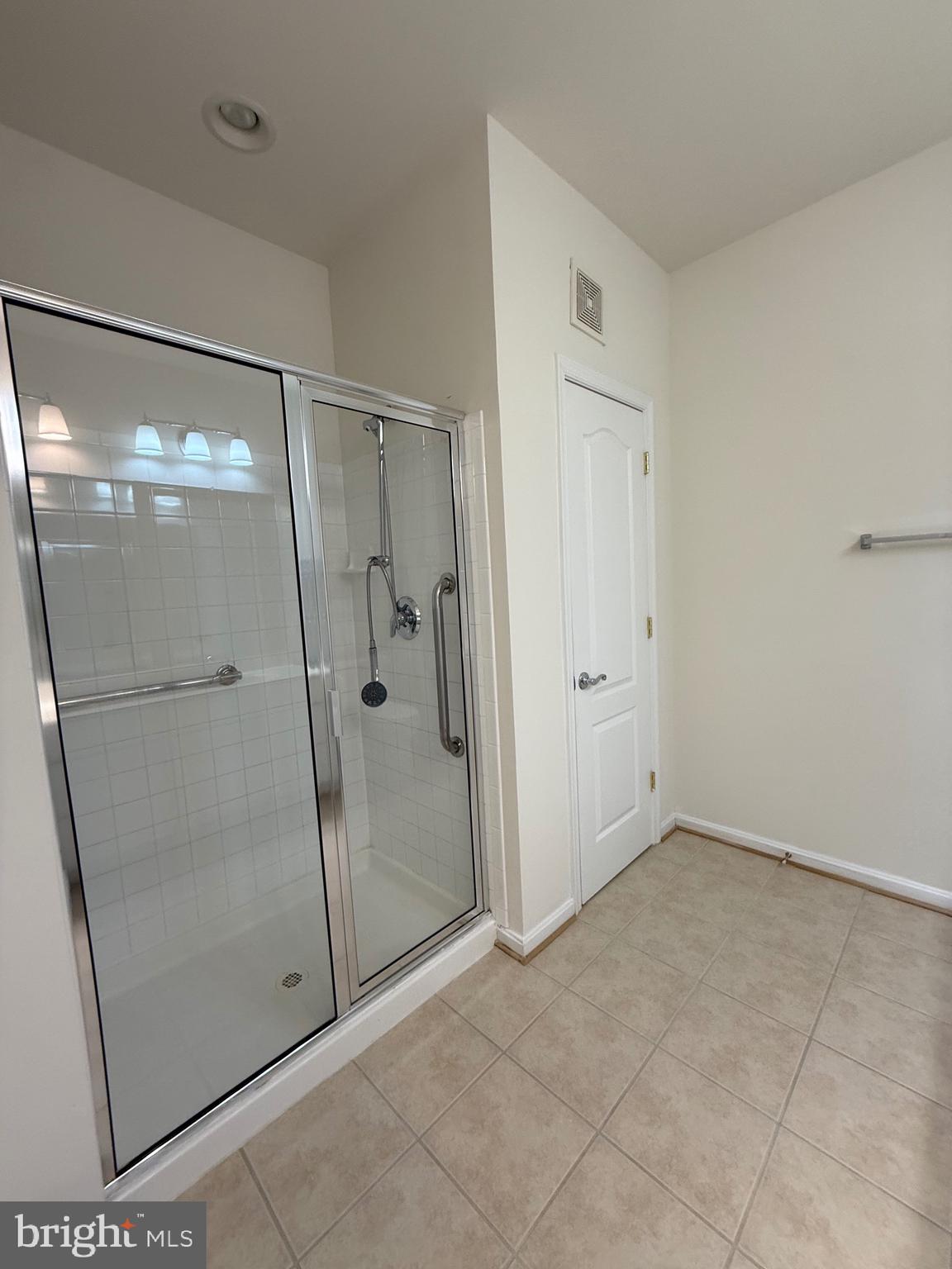 8615 Wandering Fox Trail, Unit 208 Odenton, MD 21113 - Photo 17 of 28 a bathroom with a glass shower door