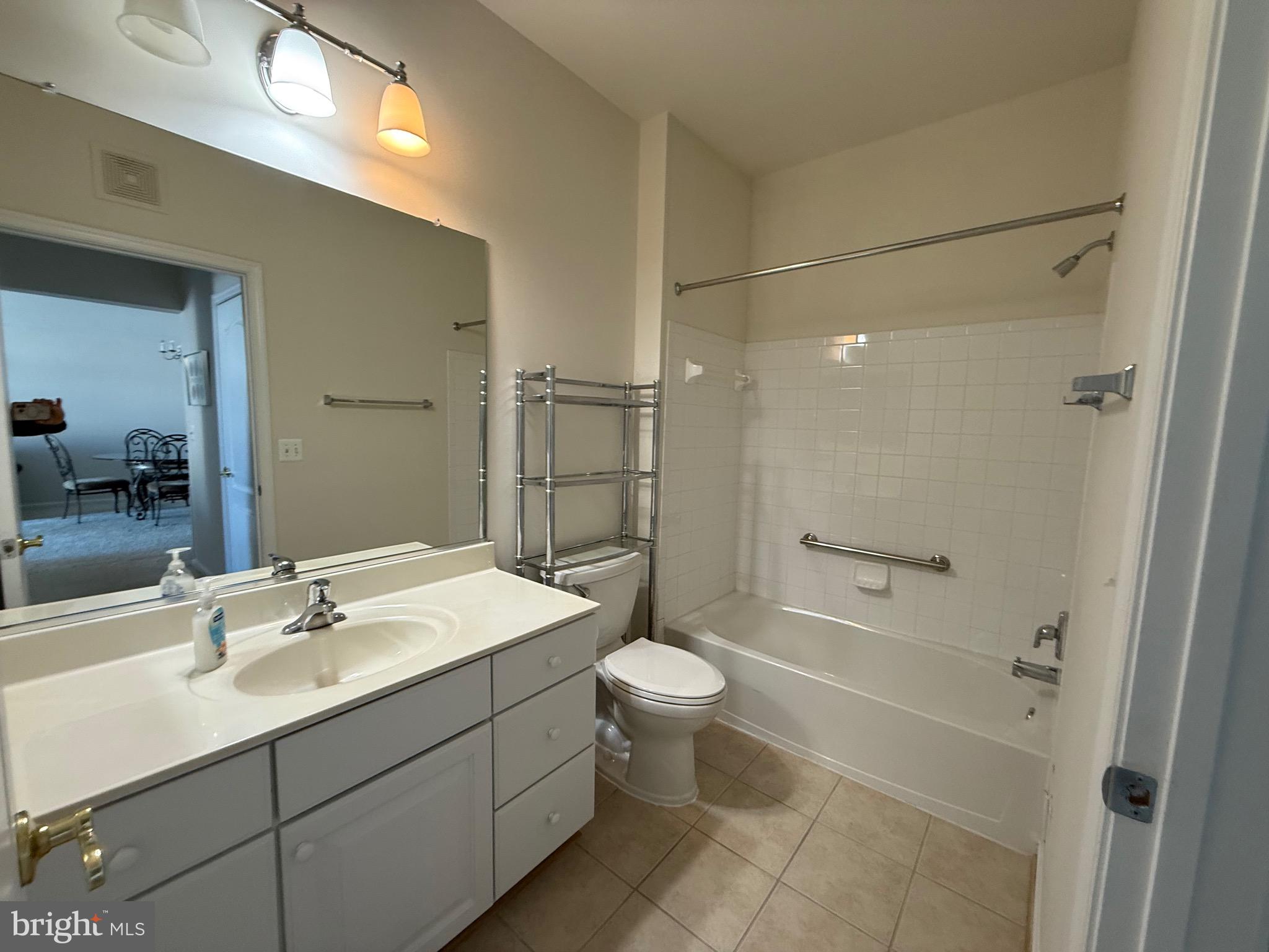 8615 Wandering Fox Trail, Unit 208 Odenton, MD 21113 - Photo 20 of 28 a bathroom with a sink toilet and shower