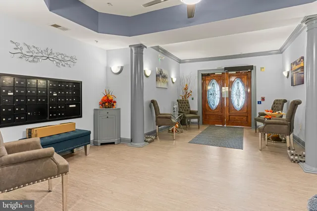 a living room with furniture gym equipment and a large window