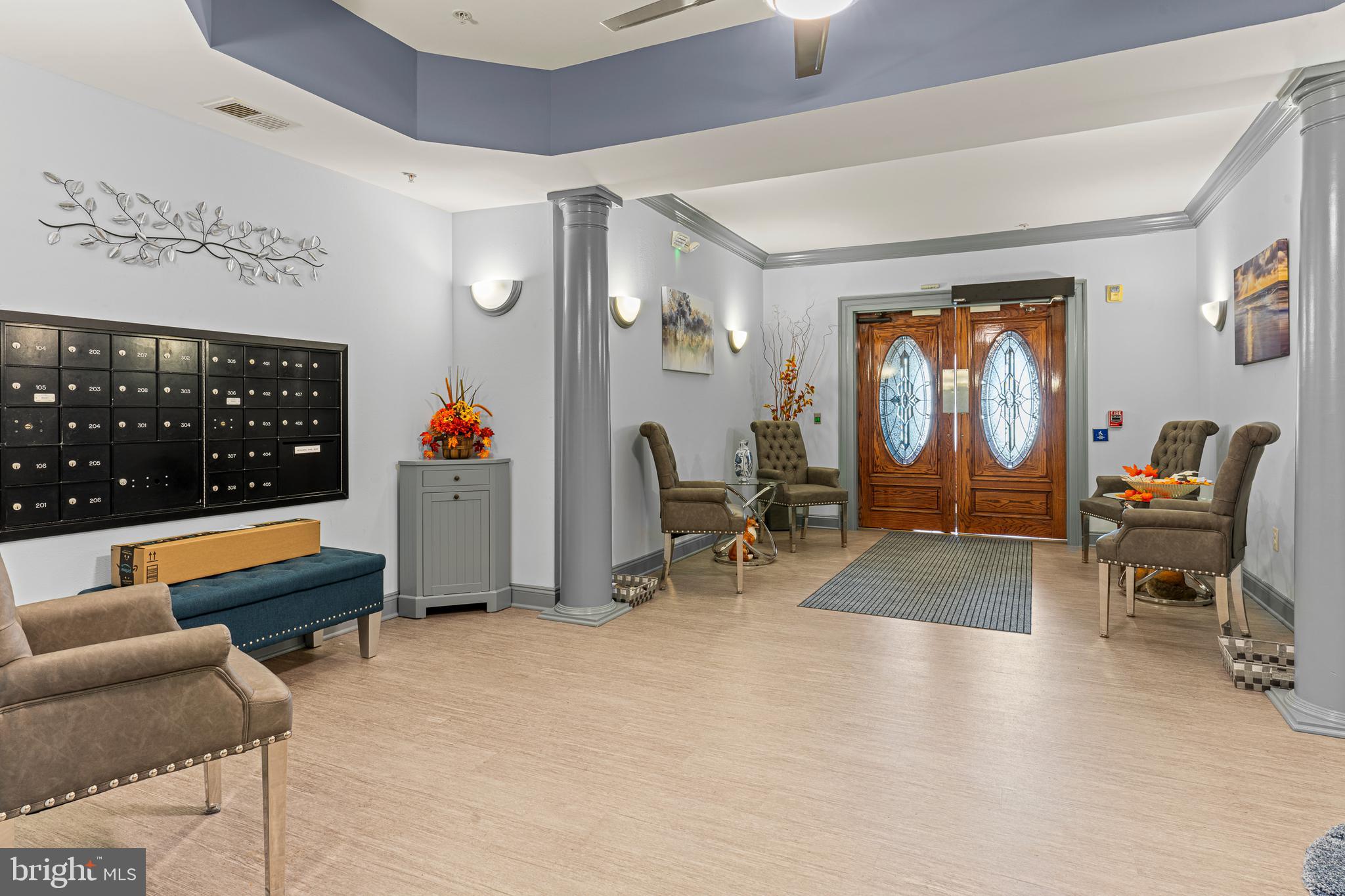 8615 Wandering Fox Trail, Unit 208 Odenton, MD 21113 - Photo 2 of 19 a living room with furniture gym equipment and a large window