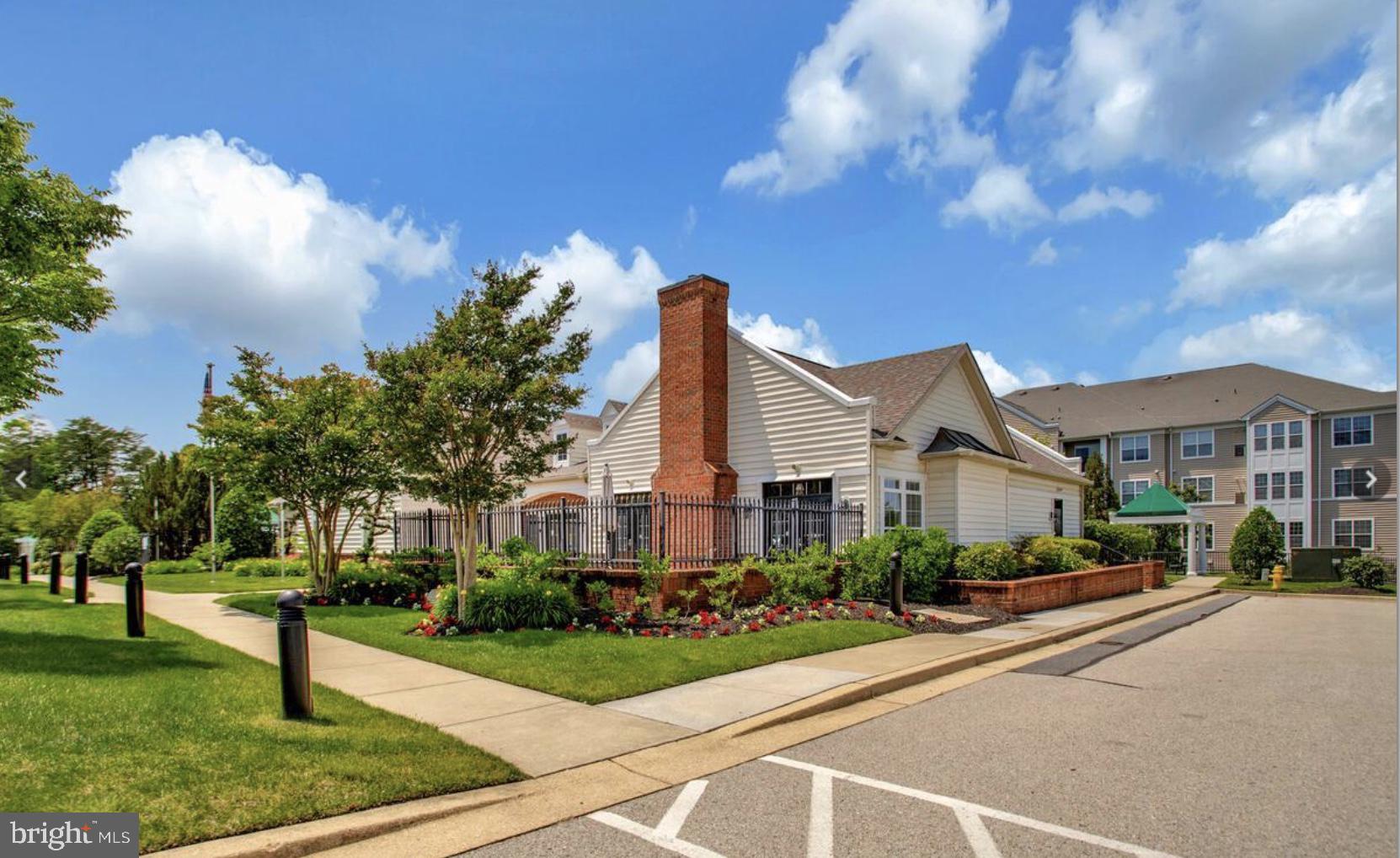 8615 Wandering Fox Trail, Unit 208 Odenton, MD 21113 - Photo 21 of 28 a front view of a house with garden