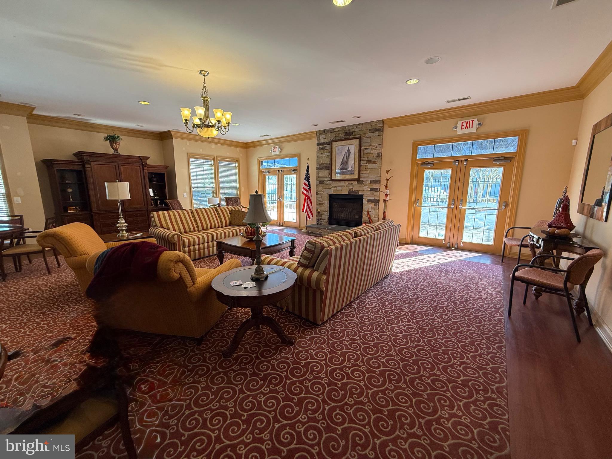 8615 Wandering Fox Trail, Unit 208 Odenton, MD 21113 - Photo 22 of 28 a living room with furniture flat screen tv and a fireplace