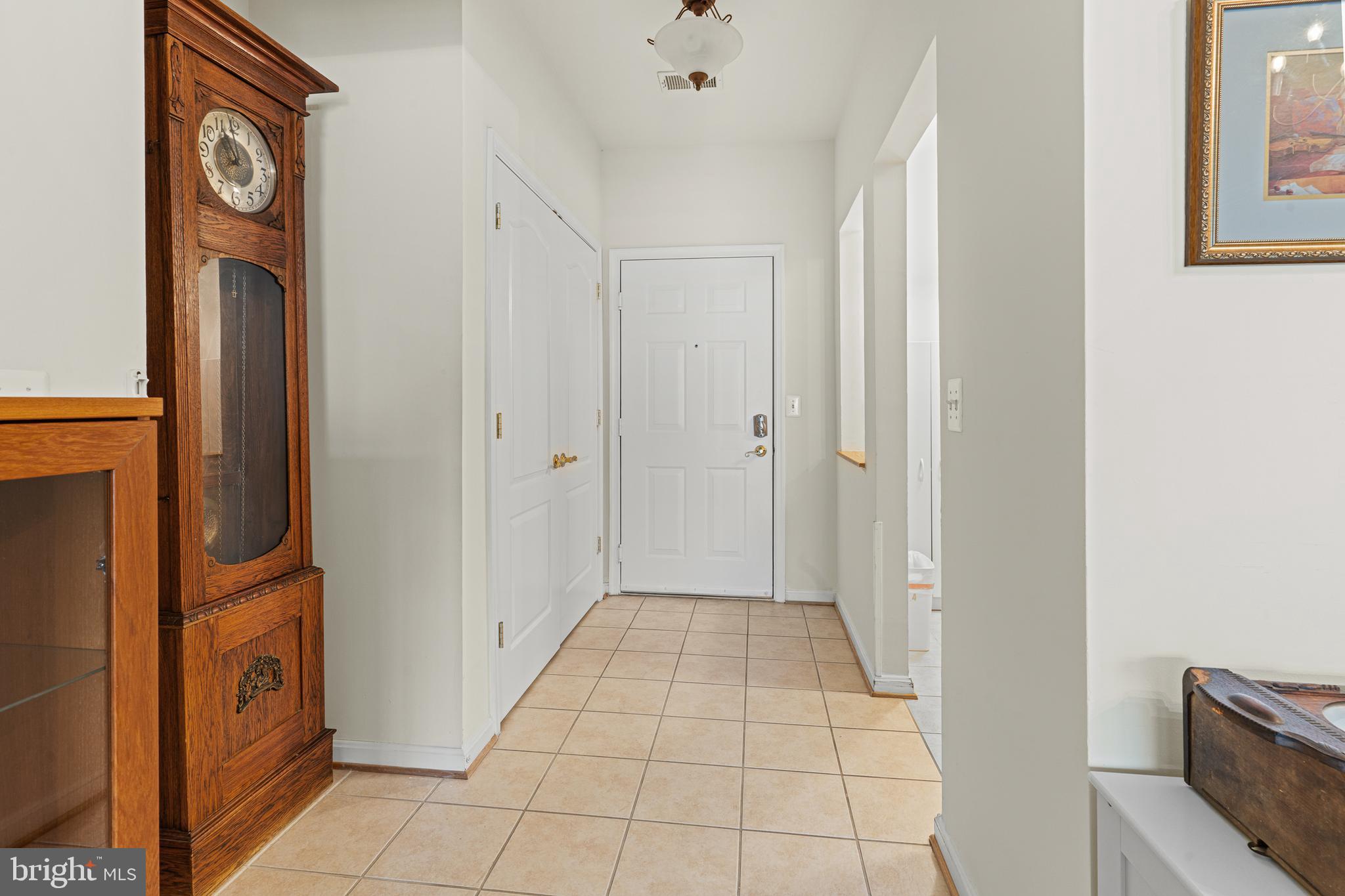 8615 Wandering Fox Trail, Unit 208 Odenton, MD 21113 - Photo 4 of 19 a view of a hallway with washer and dryer