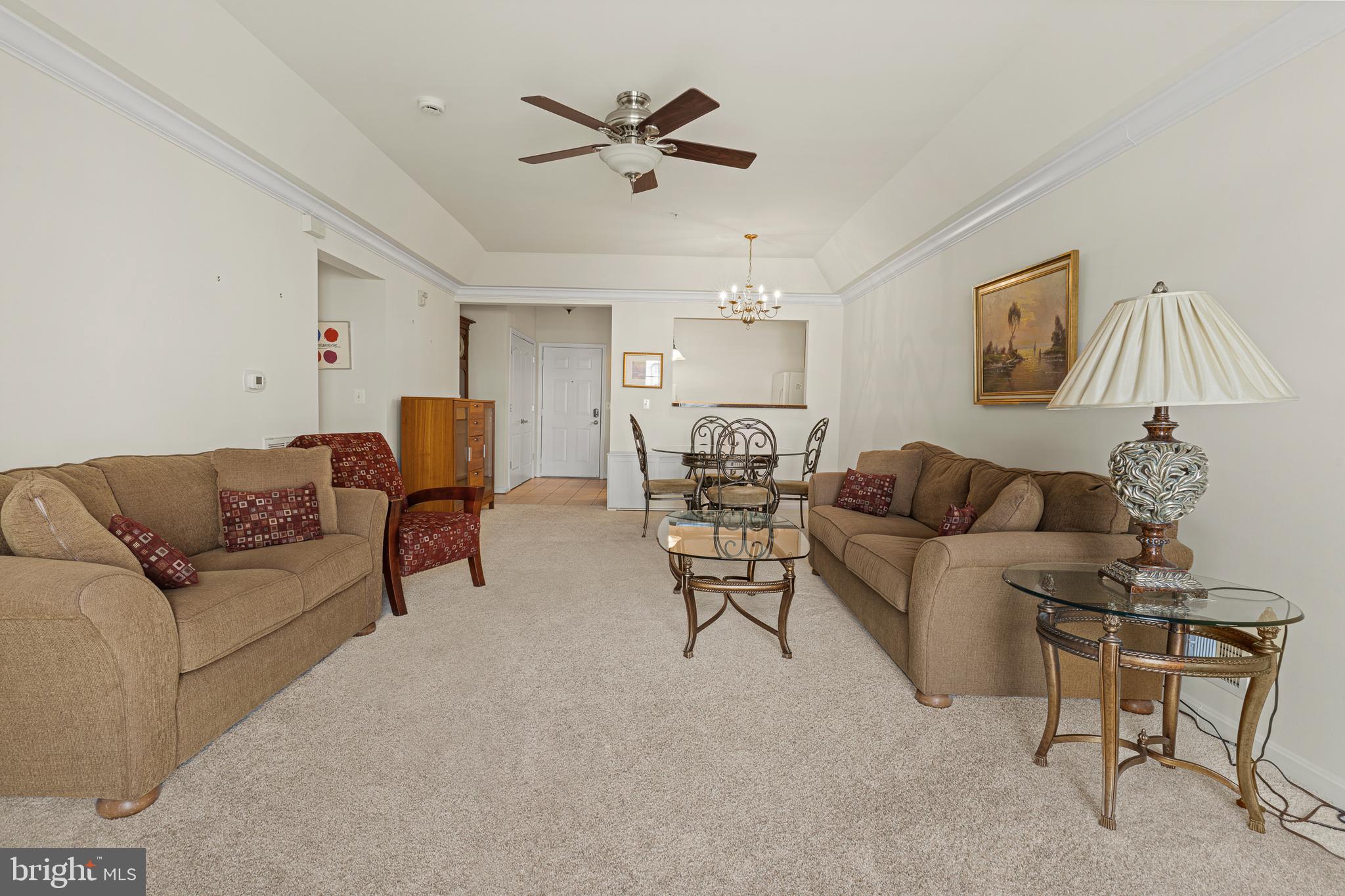 8615 Wandering Fox Trail, Unit 208 Odenton, MD 21113 - Photo 7 of 19 a living room with furniture and a ceiling fan