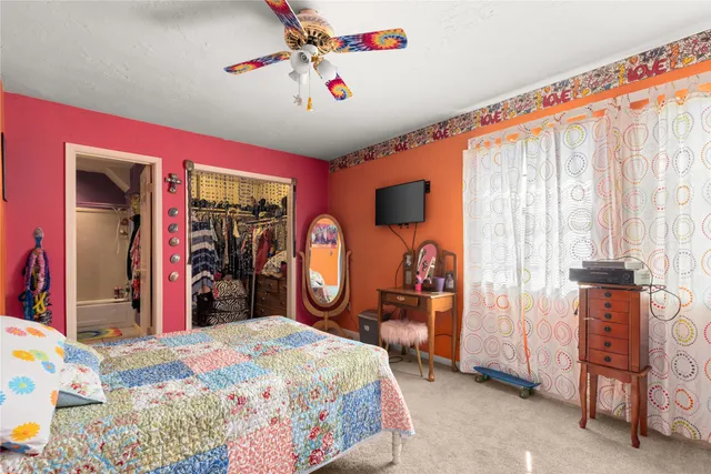 a bedroom with bed and table