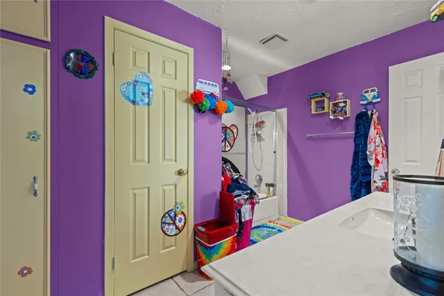 a utility room with fridge dryer and bicycles