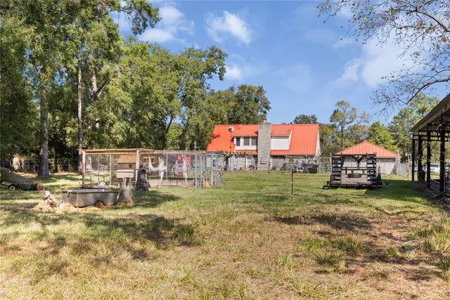 a view of a house with a yard and table and chairs